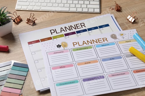 Preview: Planners, keyboard and stationery on wooden desk