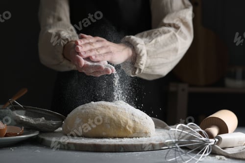 Preview: Making dough. Woman adding flour at grey table, closeup