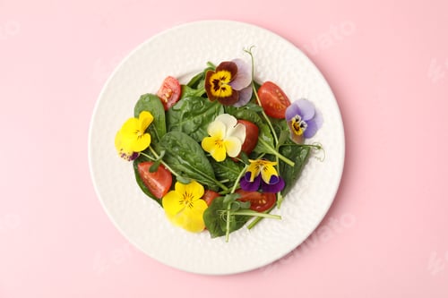 Preview: Fresh salad with pansy flowers, microgreens, tomatoes and spinach on pink table, top view