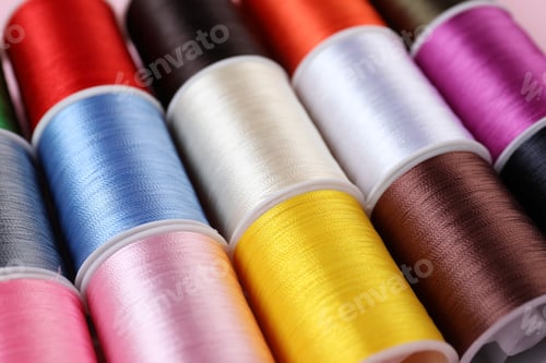 Preview: Spools of sewing threads as background, closeup