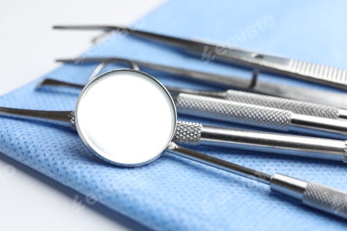 Preview: Many different dental tools and medical napkin on white table, closeup