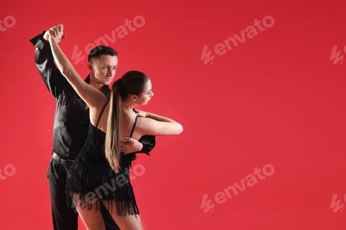 Preview: Couple of professional dancers on red background. Space for text