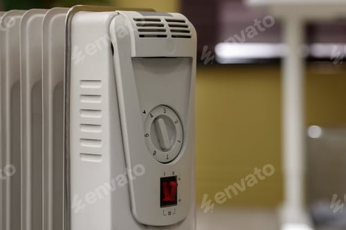 Preview: Electric heater in room, closeup. Space for text
