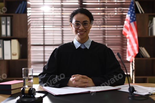 Preview: Portrait of judge in glasses at desk indoors