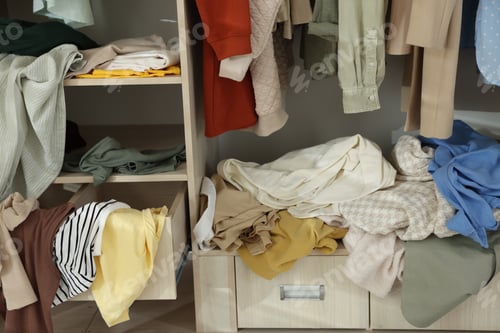 Preview: Many different messy clothes in wardrobe indoors, closeup
