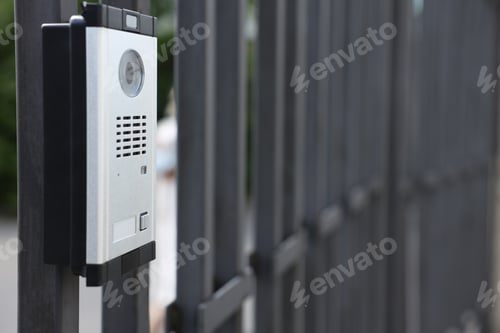 Preview: Modern intercom system on gate outdoors, closeup. Space for text