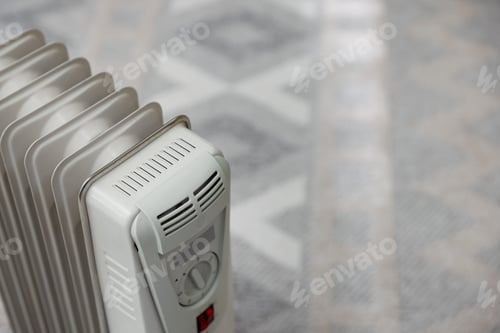 Preview: Electric heater in room, closeup. Space for text