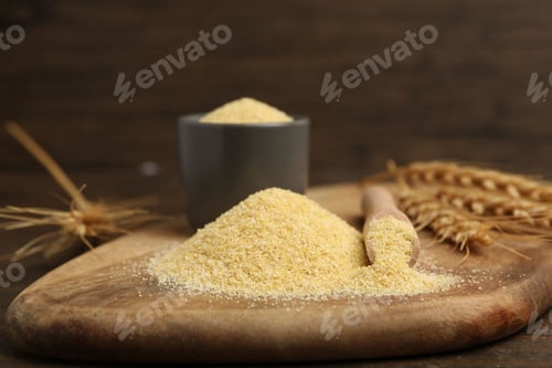 Preview: Raw semolina and spikes on wooden table, closeup