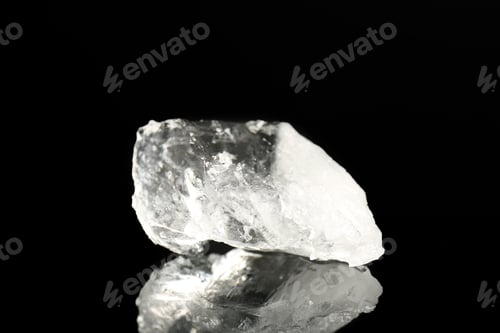 Preview: Piece of clear ice on black mirror surface