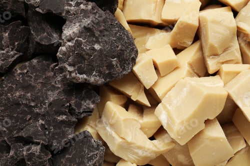 Preview: Organic cocoa butter and chocolate pieces as background, top view