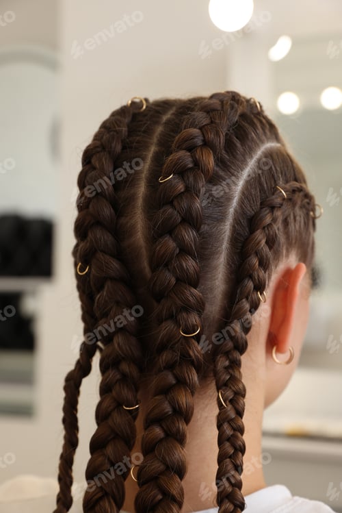 Preview: Teenage girl with beautiful braids in salon, closeup
