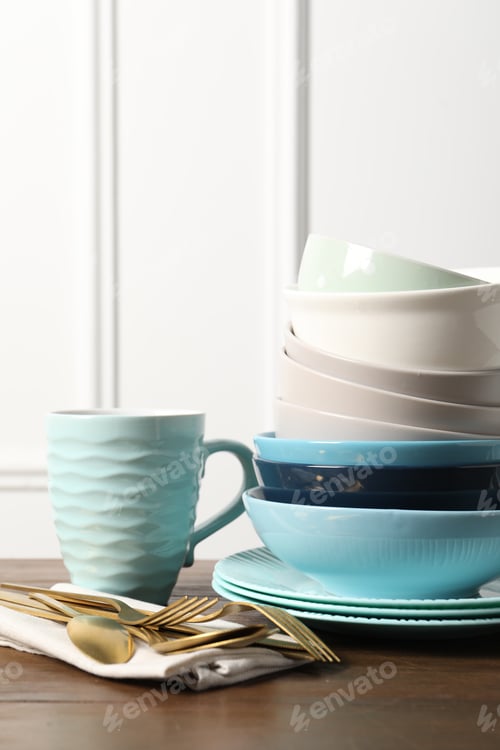 Preview: Beautiful ceramic dishware, cup and cutlery on wooden table