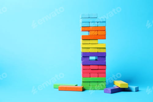 Preview: Tower of colorful blocks on light blue background. Space for text