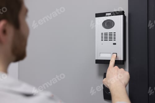 Preview: Man pressing button on intercom panel indoors, closeup