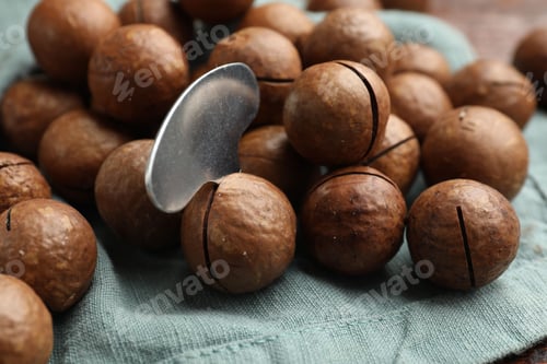Preview: Macadamia nuts and metal key on light blue napkin, closeup
