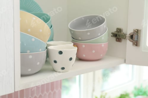 Preview: Cabinet with different clean dishware in kitchen, closeup