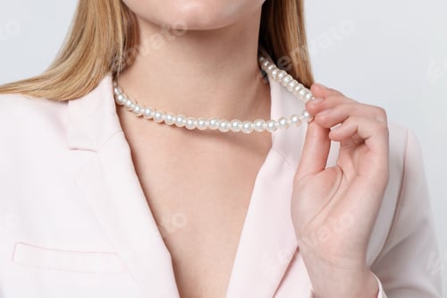 Preview: Woman wearing stylish necklace on white background, closeup