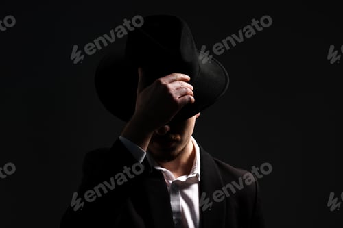 Preview: Man in stylish hat on dark background