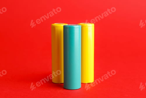 Preview: Many alkaline batteries on red background, closeup