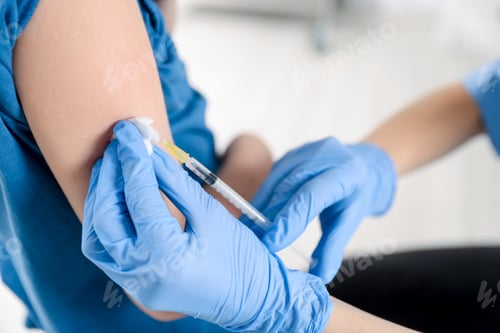 Preview: Nurse vaccinating little boy in clinic, closeup