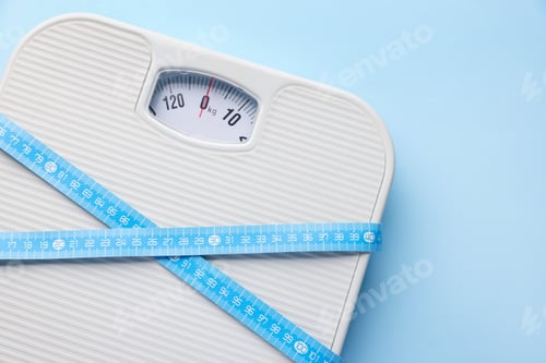 Preview: Scales with measuring tape on light blue background, top view