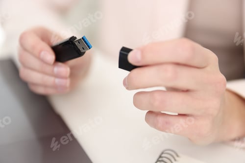 Preview: Woman with USB flash drive at desk, closeup