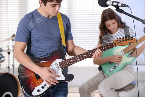 Preview: Teenage music band practicing their performance indoors