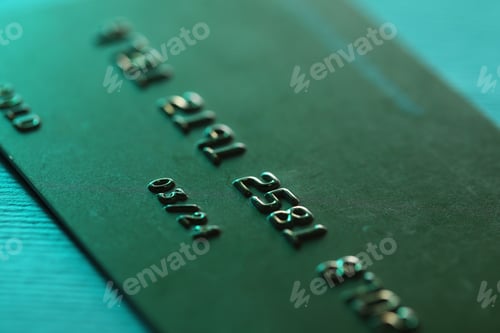 Preview: One credit card on turquoise background, macro view