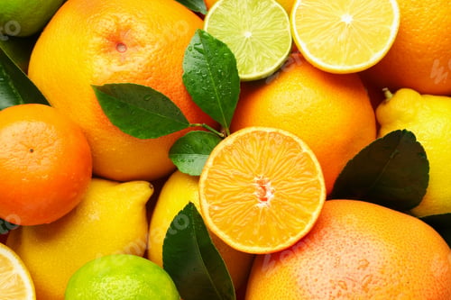 Preview: Different ripe citrus fruits and leaves as background, closeup