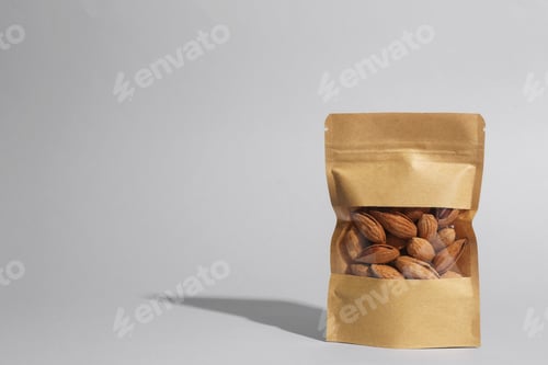 Preview: Stand-up pouch with almond nuts on grey background, space for text