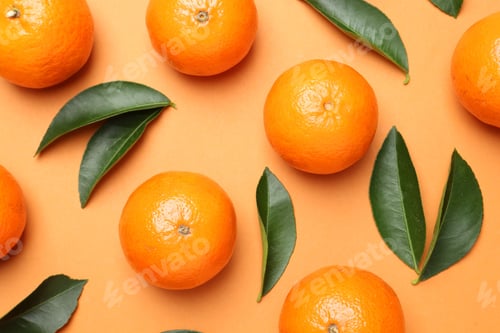 Preview: Fresh ripe tangerines and leaves on orange background, flat lay