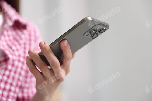 Preview: Woman sending text message via smartphone indoors, closeup. Space for text