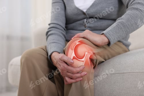 Preview: Senior woman suffering from arthritis at home, closeup. Illustration of knee joint inflammation on h
