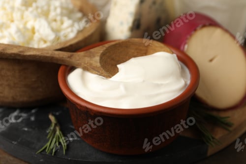 Preview: Different dairy products and rosemary on table, closeup