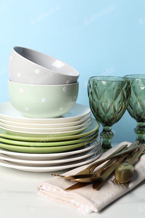 Preview: Beautiful ceramic dishware, glasses and cutlery on white marble table