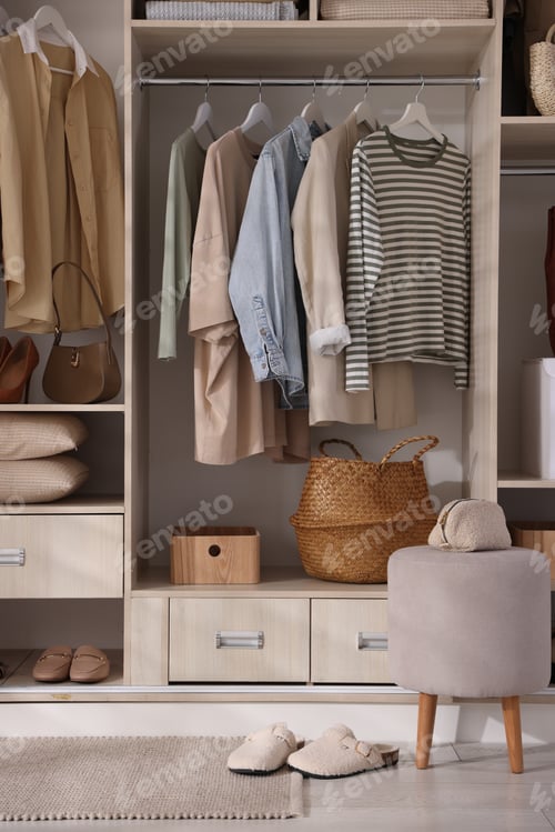 Preview: Wardrobe with different neatly organized clothes and home stuff indoors