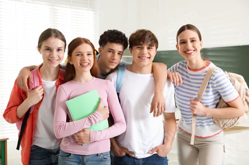 Preview: Portrait of happy students together in classroom