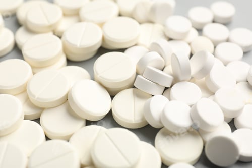 Preview: Many pills on light grey background, closeup