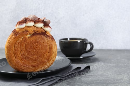 Preview: Round croissant with chocolate chips and cream served on grey table, space for text. Tasty puff past