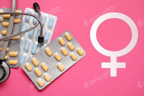 Preview: Female hormones. Many pills, stethoscope and female gender symbol on pink background, top view