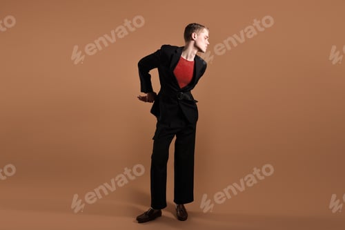 Preview: Young man in stylish clothes on brown background