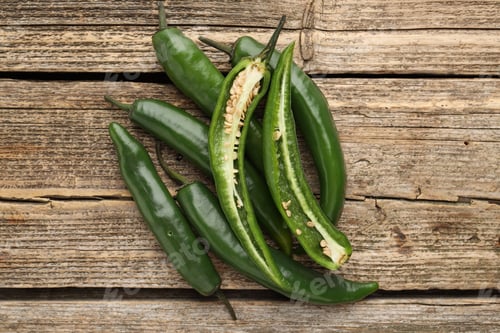 Preview: Fresh green chili peppers on wooden table, top view