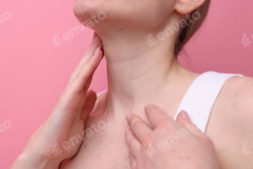 Preview: Beautiful woman touching her neck on pink background, closeup