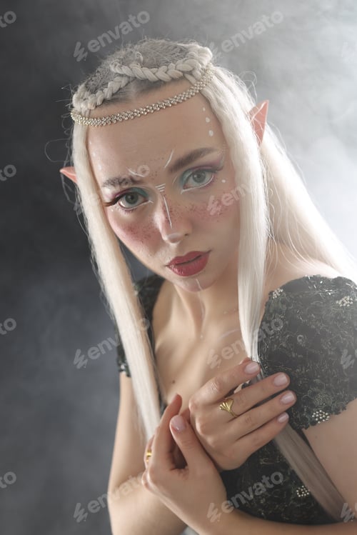 Preview: Beautiful girl dressed as elf on black background with smoke