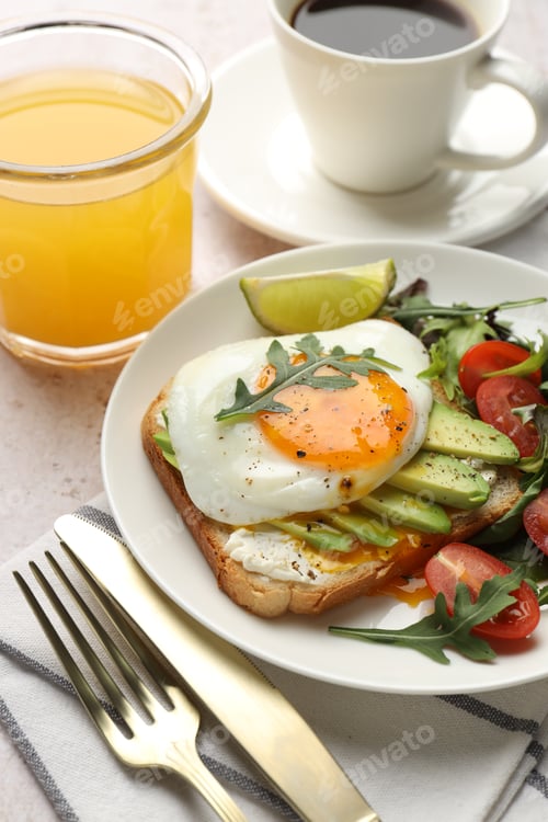 Preview: Healthy breakfast with avocado toast served on light table, closeup