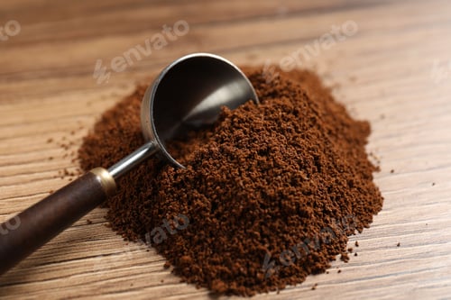 Preview: Ground coffee and scoop on wooden table, closeup