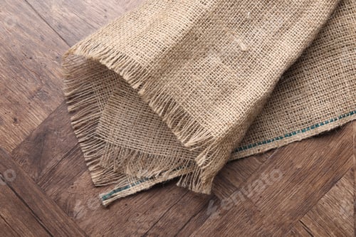 Preview: Natural burlap fabric on wooden table, top view