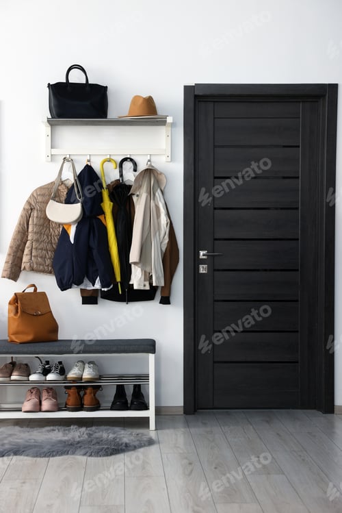 Preview: Shoe storage bench with different footwear and coats in hallway. Interior design