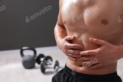 Preview: Young man with muscular body indoors, closeup
