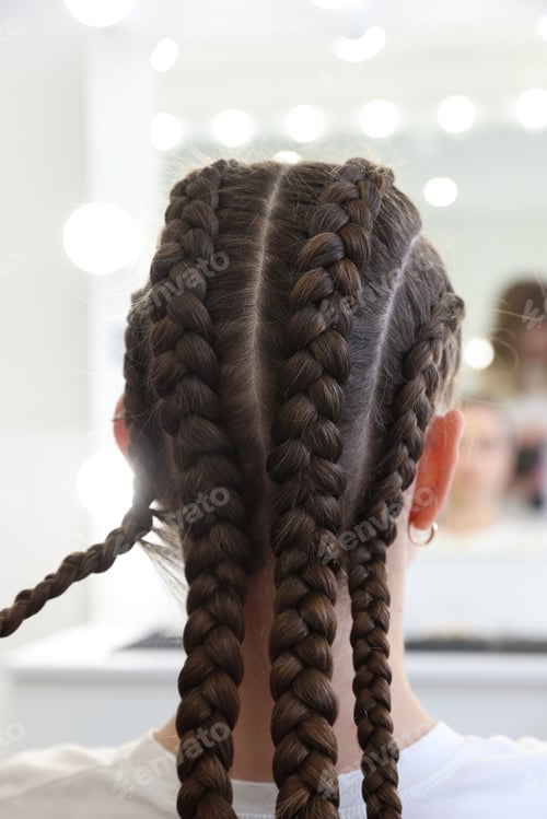 Preview: Teenage girl with beautiful braids indoors, back view